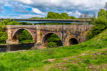 Fototapeta na wymiar A view towards the Medieval bridge at Leaderfoot in Scotland on a summers day 