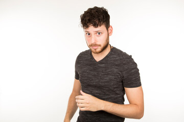 Serious dark-haired Caucasian young man with beard looking at camera