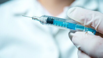 A little single glass bottle vial of new Covid-19 vaccine. Healthcare concept vaccination injection treatment.