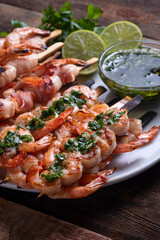 Seafood: shrimp in bacon and shrimp with garlic and herbs on skewers