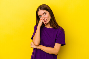 Young caucasian woman isolated on yellow background tired of a repetitive task.