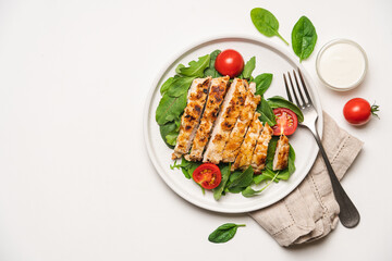 Chopped chicken breast steak with salad. White background with copy space