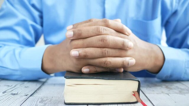 young man hand on a bibel 