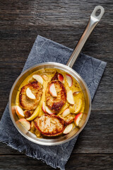 pork chops in apple cider cream sauce in a pan
