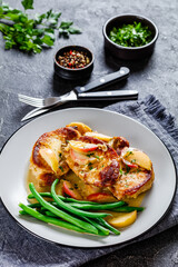 pork chops in apple cider cream sauce on a plate