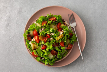 Light summer fresh salad with tomatoes and lettuce, chicken breast and pineapple with balsamic sauce, top view