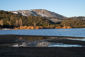 The Andes mountains, forest and Alumine lake at sunset in Villa Pehuenia, Patagonia Argentina. 