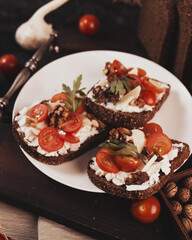 Sandwiches with cheese and tomatoes on the table