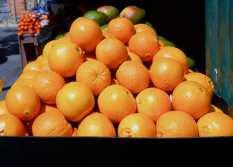 Sidewalk market display of oranges.
