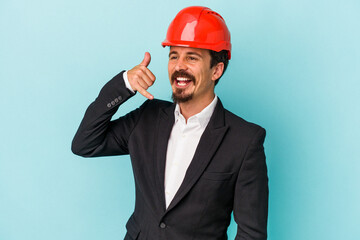 Young architect caucasian man isolated on blue background showing a mobile phone call gesture with fingers.