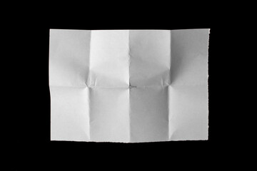 White paper sheet with bends isolated on black background.