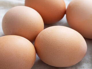 Chicken eggs lie on a fabric surface, close-up. Multi-colored chicken eggs.