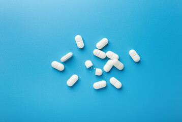 Top View Of White Pills On Blue Background