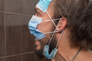 The man is protected by three medical masks at once