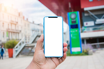 Man's hand using cellphone outdoor, Man typing text message on smart phone blurred city background