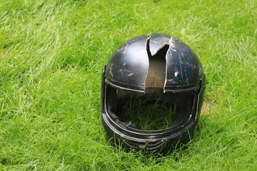 Fototapeten broken motorcycle helmet on the ground © serikbaib
