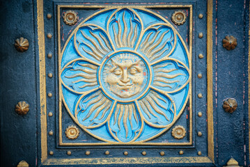 A golden paiting on entrance to vysehrad castle in prague city. Flower with golden sun face. Czech republic