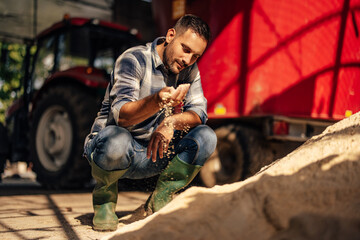 Adult man, checking if the ground is fertile.