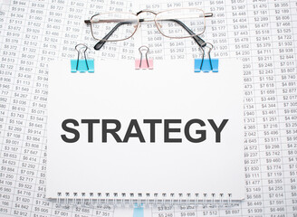 strategy text written on paper with pen and glasses