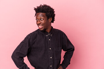 Young african american man isolated on pink background confident keeping hands on hips.