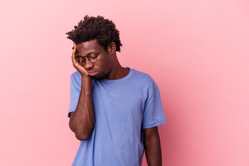 Young african american man isolated on pink background who is bored, fatigued and need a relax day.