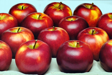 close up shot of a group of many freshness red apples with some yellow color marks