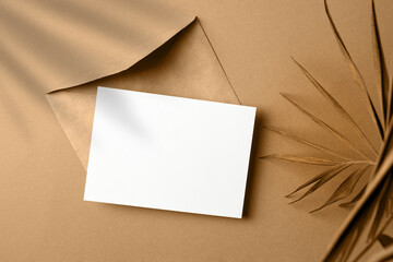Fototapeta premium Invitation card mockup with palm tree leaf decoration