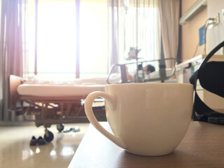 A white cup of coffee placed in a hospital room