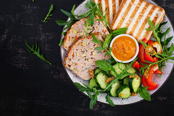 Chicken meatloaf and fresh salad and toasts. Healthy lunch or dinner. Top view, overhead