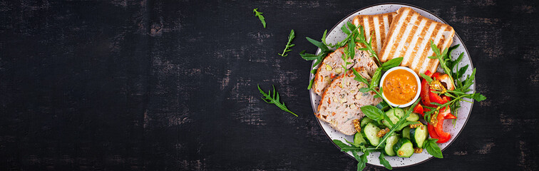 Chicken meatloaf and fresh salad and toasts. Healthy lunch or dinner. Top view, banner, overhead