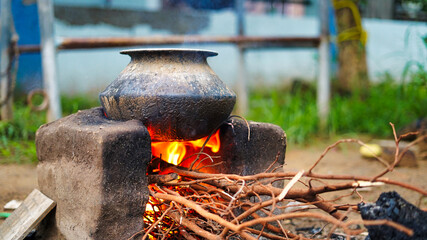 Traditional Indian earthen cooking stove Countryside stove or Chulha or clay stove with a black...