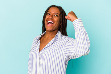 Young african american woman isolated on blue background  celebrating a victory, passion and enthusiasm, happy expression.