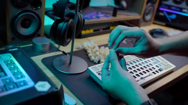A footage of a man assemble a DIY premium custom keyboard build kit with full alluminium base and bright RGB LED Colors
