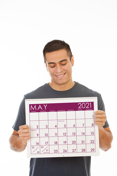 Smiling Man Holds May 2021 Calendar