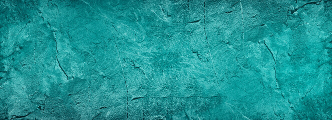 Blue green abstract background. Toned rock surface texture. Beautiful teal background with copy space for design. Wide banner.