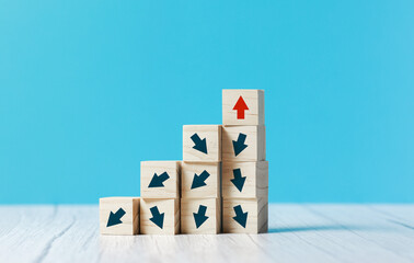 wooden block cubes with rising business graph among decline graph