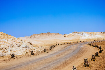 Driveway in Ras Mohamed National Park. Ras Muhammad in Egypt at the southern extreme of the Sinai Peninsula. The road in desert. - obrazy, fototapety, plakaty