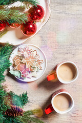 Fototapeta na wymiar Merry Christmas background with Xmas decors and cookies. Tasty Christmas cookies and X-mas tree baubles. Celebrating Christmas and New year