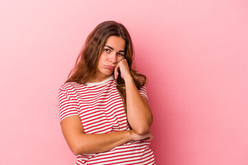 Young caucasian woman isolated on pink background  who feels sad and pensive, looking at copy space.