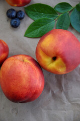 Nectarine. Ripe juicy organic nectarines (peaches). Close-up. Whole fruits on craft paper. Healthy food concept. Vegetarianism. View from above. Copy space.