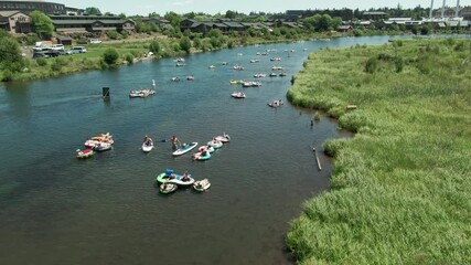 Aerial: People in rubbers tires floating down the Deschutes River, Bend, Oregon