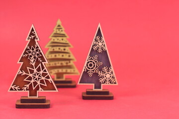 Creative wooden christmas tree made of gifts on red background