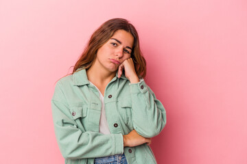 Young caucasian woman isolated on pink background  who feels sad and pensive, looking at copy space.