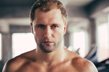 Close up portrait face of topless male intense looking at camera. Handsome athletic man sweating...