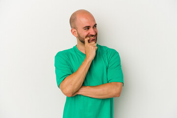 Young bald man isolated on white background relaxed thinking about something looking at a copy space.