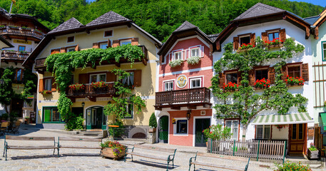 Hallstatt, Austria - July 31, 2021 - A scenic picture postcard view of the famous town square in the village of Hallstatt in the Austrian Alps.