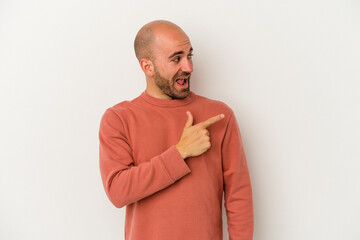 Young bald man isolated on white background looks aside smiling, cheerful and pleasant.