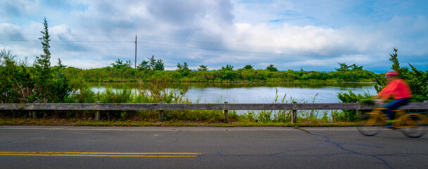 Stormy seascape along the coastal road with a view of the pond and Shining Sun Bikeways in Falmouth, Massachusetts.