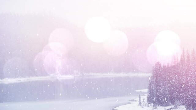 Animation of winter scenery over glowing blurred lights