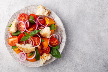 Panzanella-classic Italian salad with ciabatta, red and yellow tomatoes, red onion